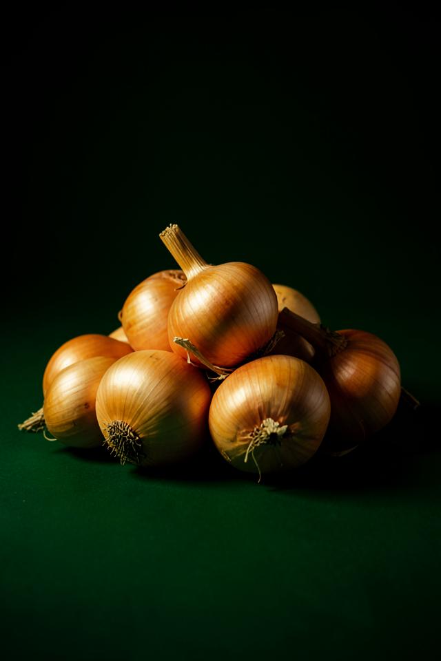 Fresh yellow onions in a wooden crate ready for wholesale supply