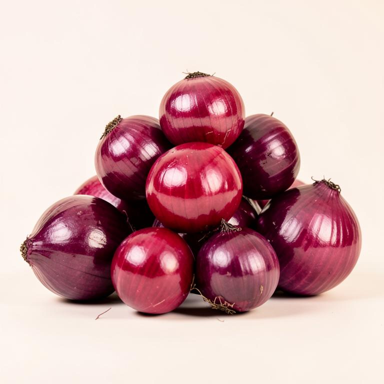 Pile of glossy red onions with deep purple skins